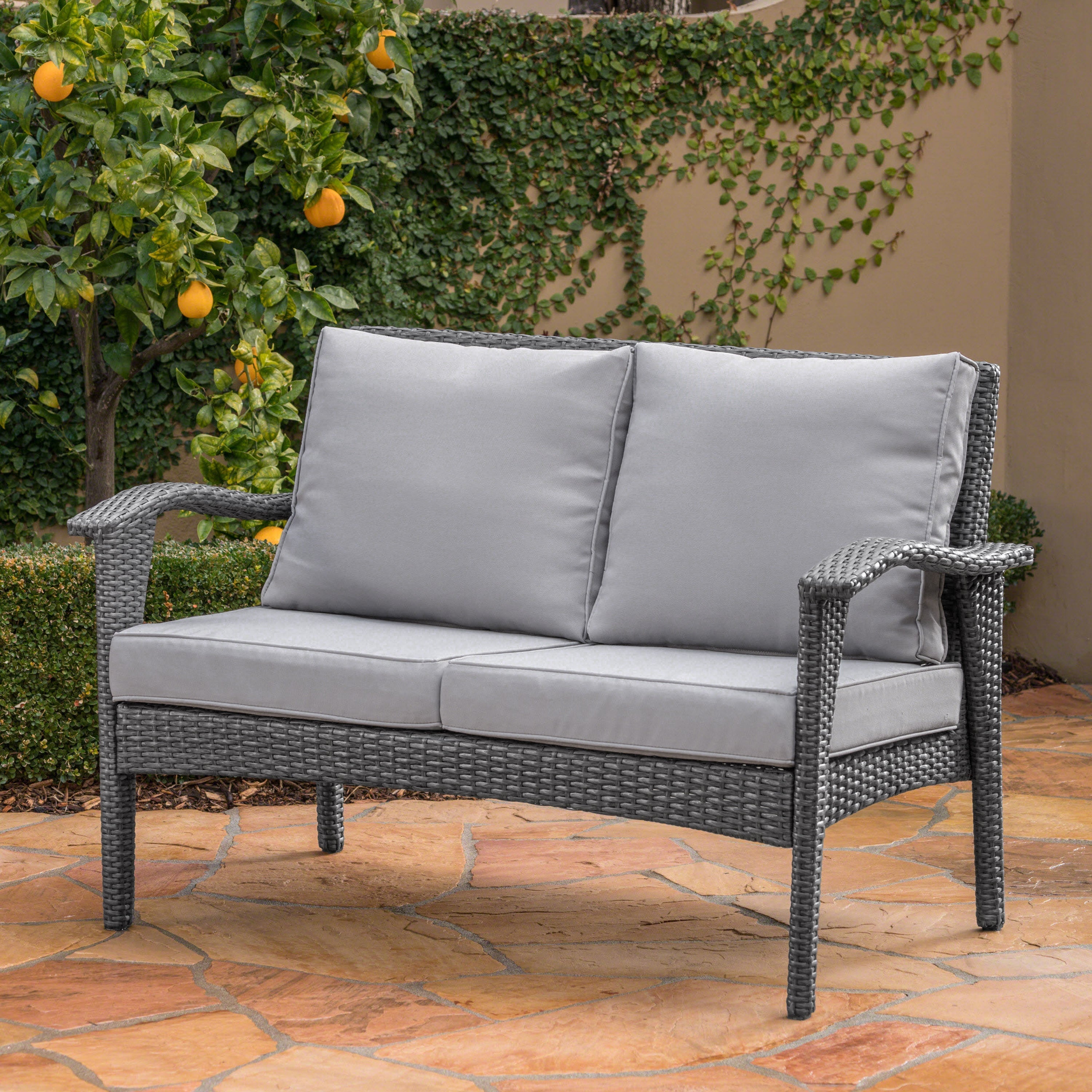 The Contoured All-Weather Wicker Loveseat by Christopher Knight Home