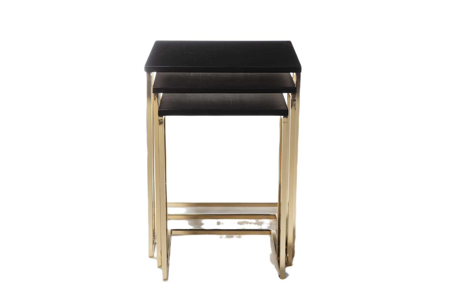 Elegant nesting table with a sleek black top and luxurious golden metal legs, ideal for any interior.