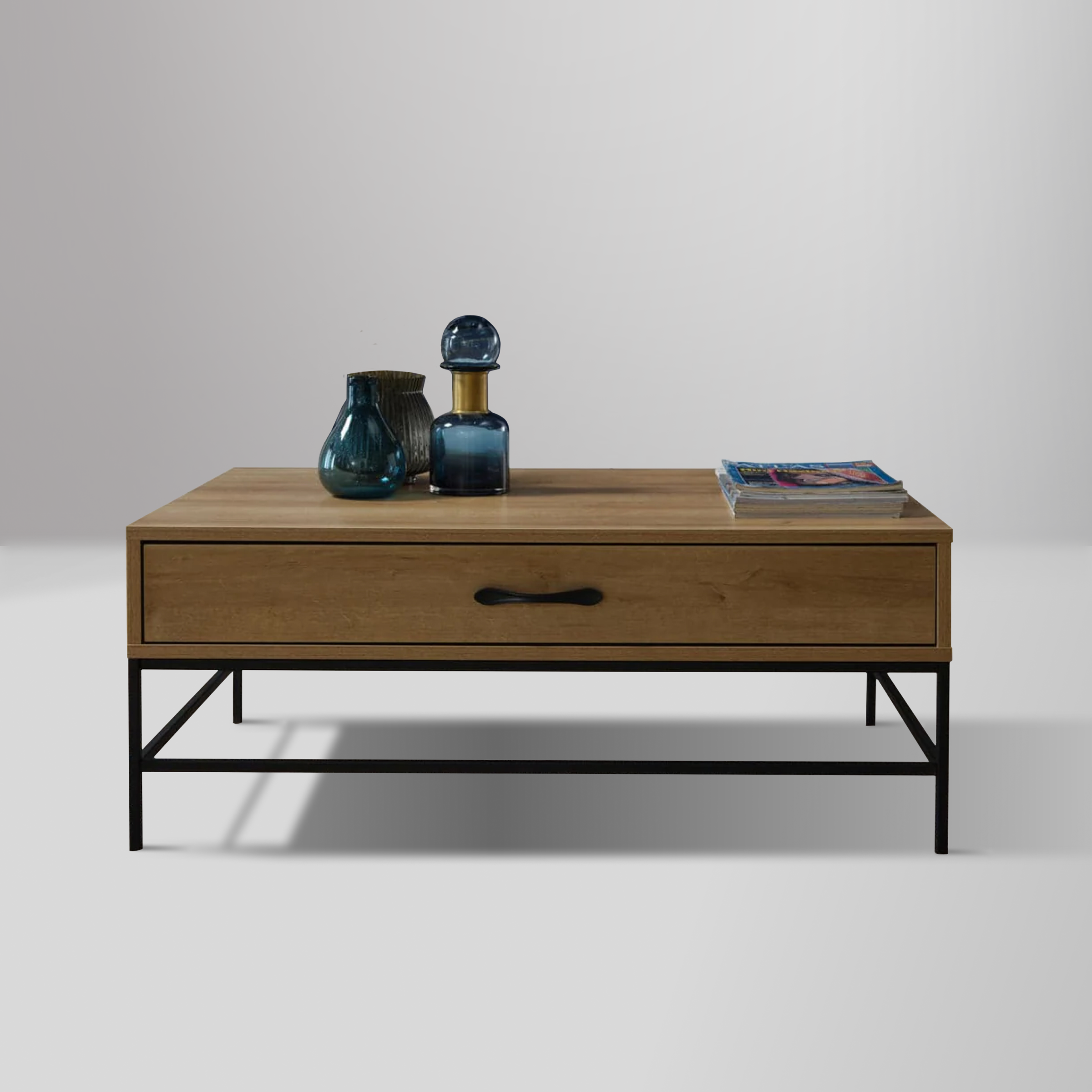 Drift Coffee Table with light finished wood body, wrought iron legs, and spacious drawer for storage.
