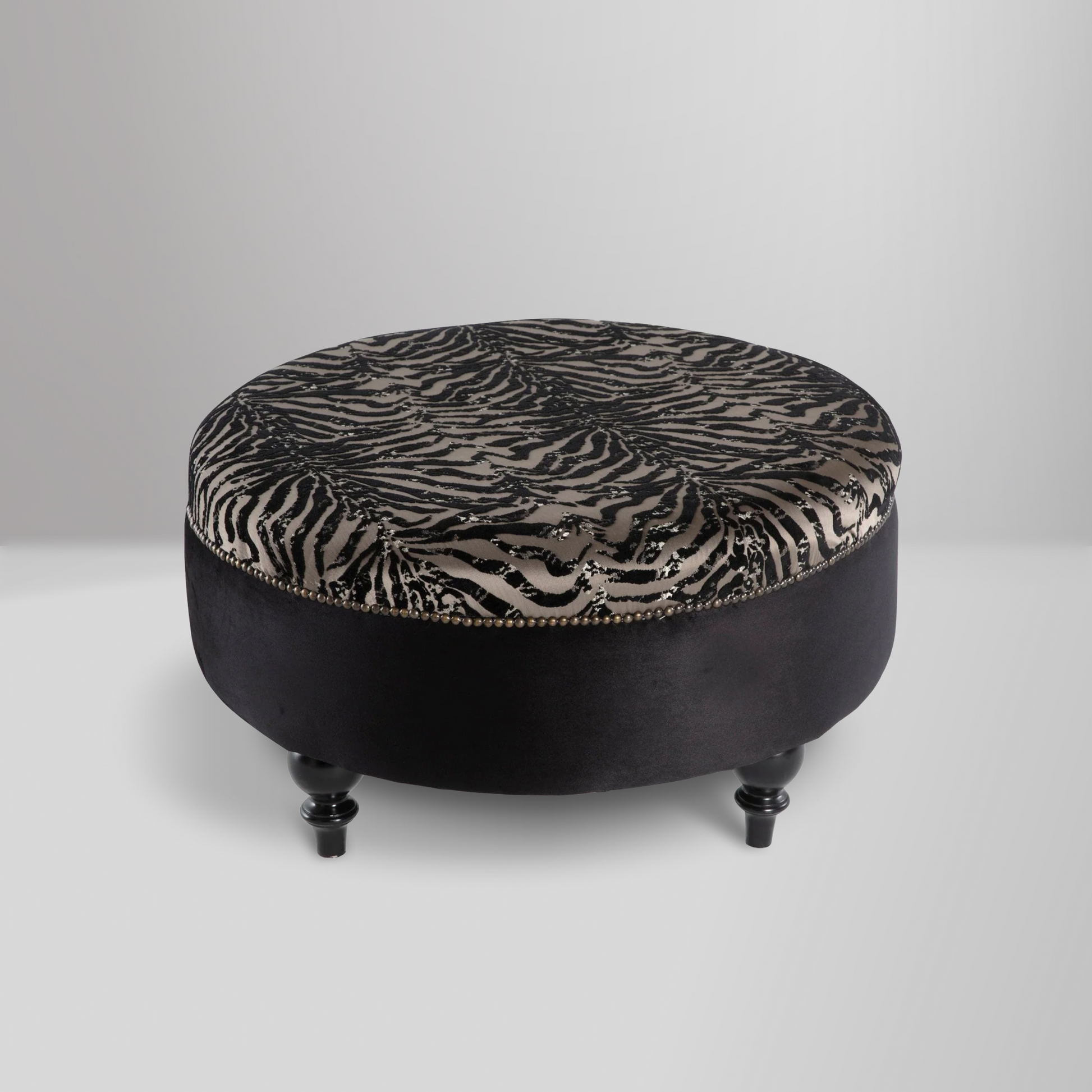 Gaze Round Ottoman with a sophisticated round design, premium cushioning, and subtle stitching details for versatile use