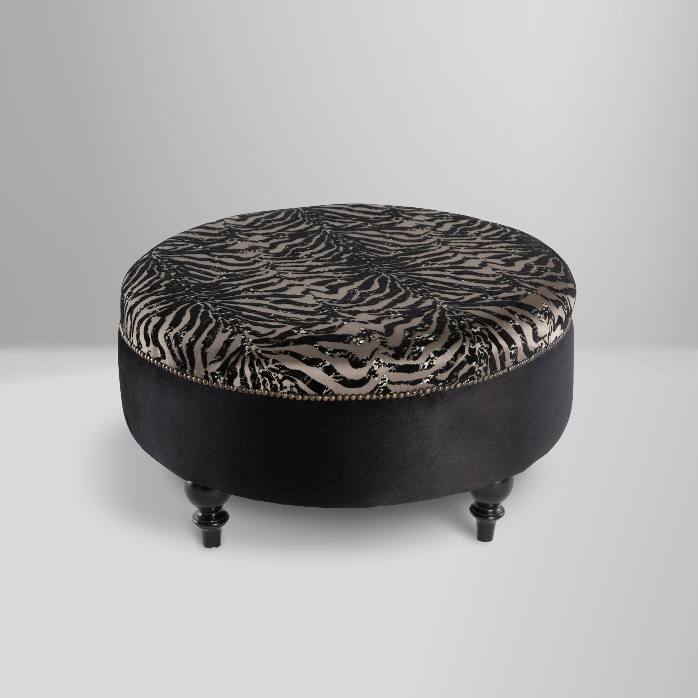 Gaze Round Ottoman with a sophisticated round design, premium cushioning, and subtle stitching details for versatile use