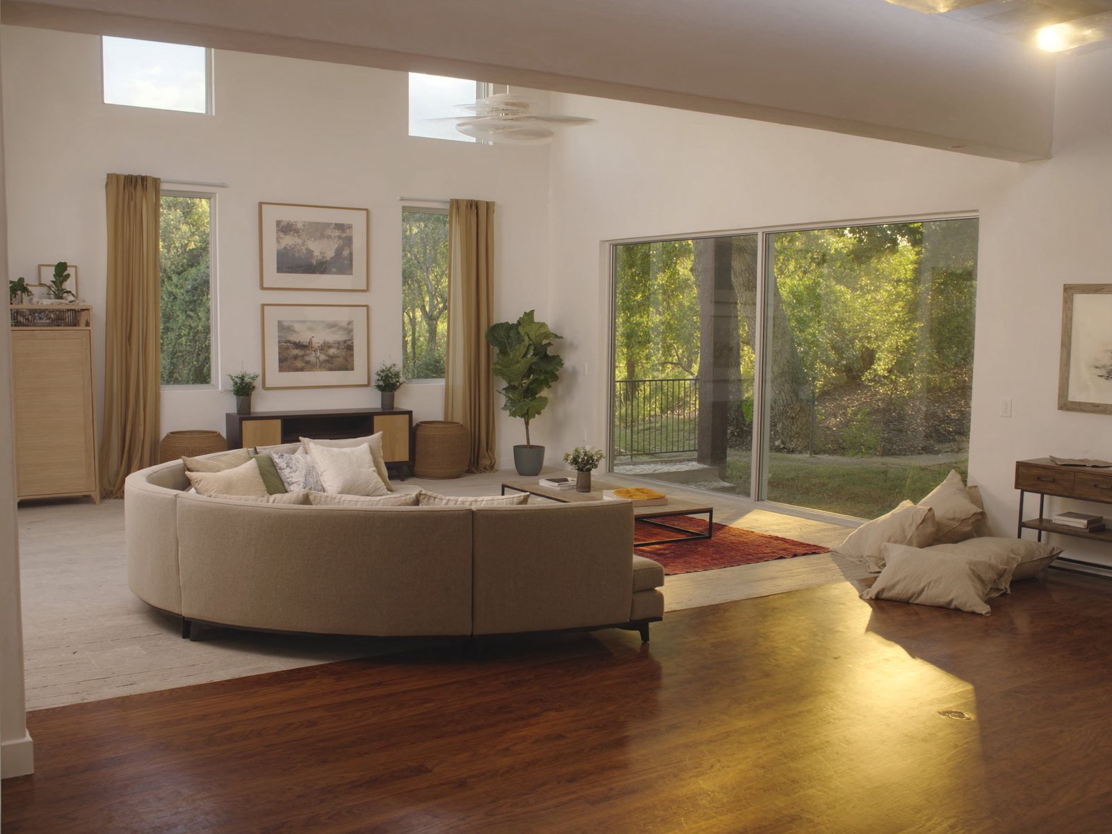 Bright open-concept living room in a new Tampa-area home with a large sand-toned sectional sofa, wood coffee table, and tropical backyard visible through floor-to-ceiling sliding glass doors